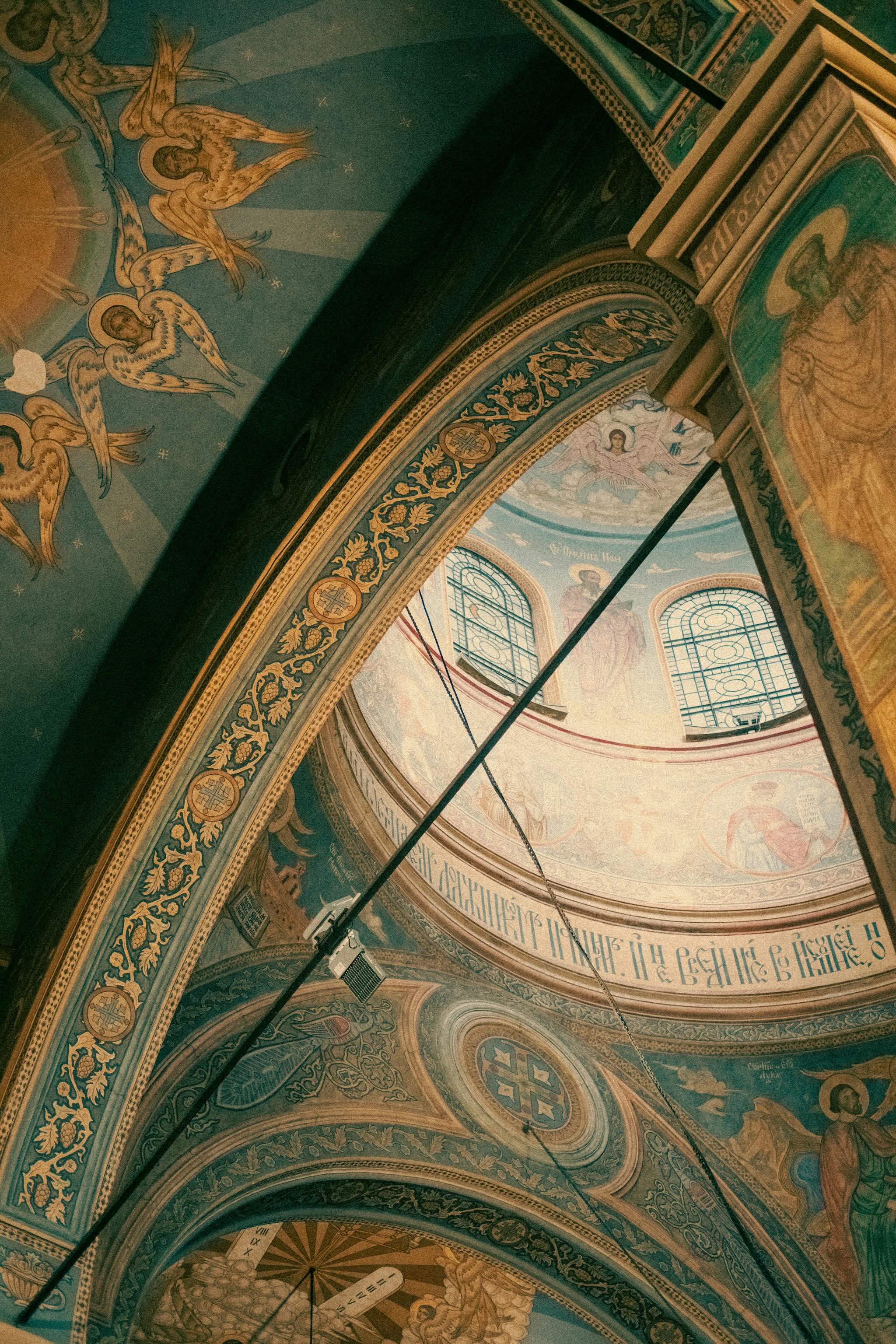 Ornate painted arch and windows inside a historic church