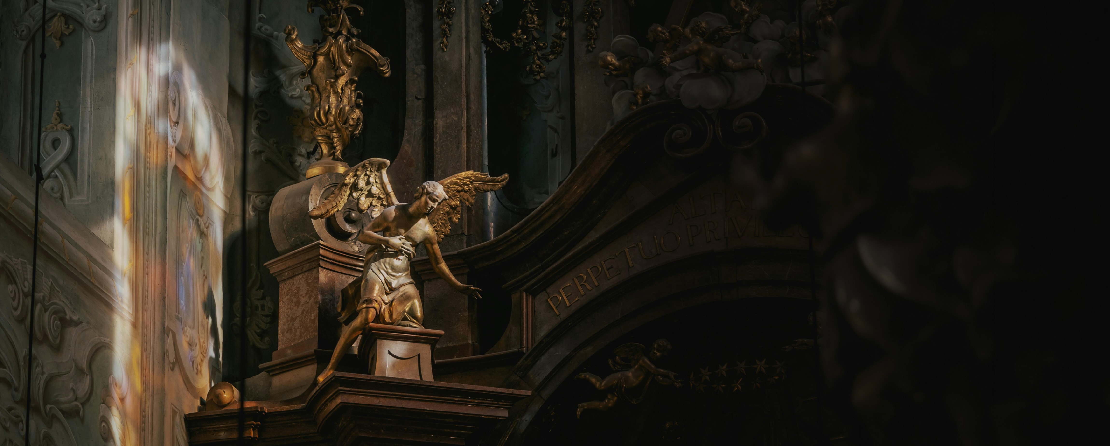 Sunlight illuminating ornate church sculpture and architecture