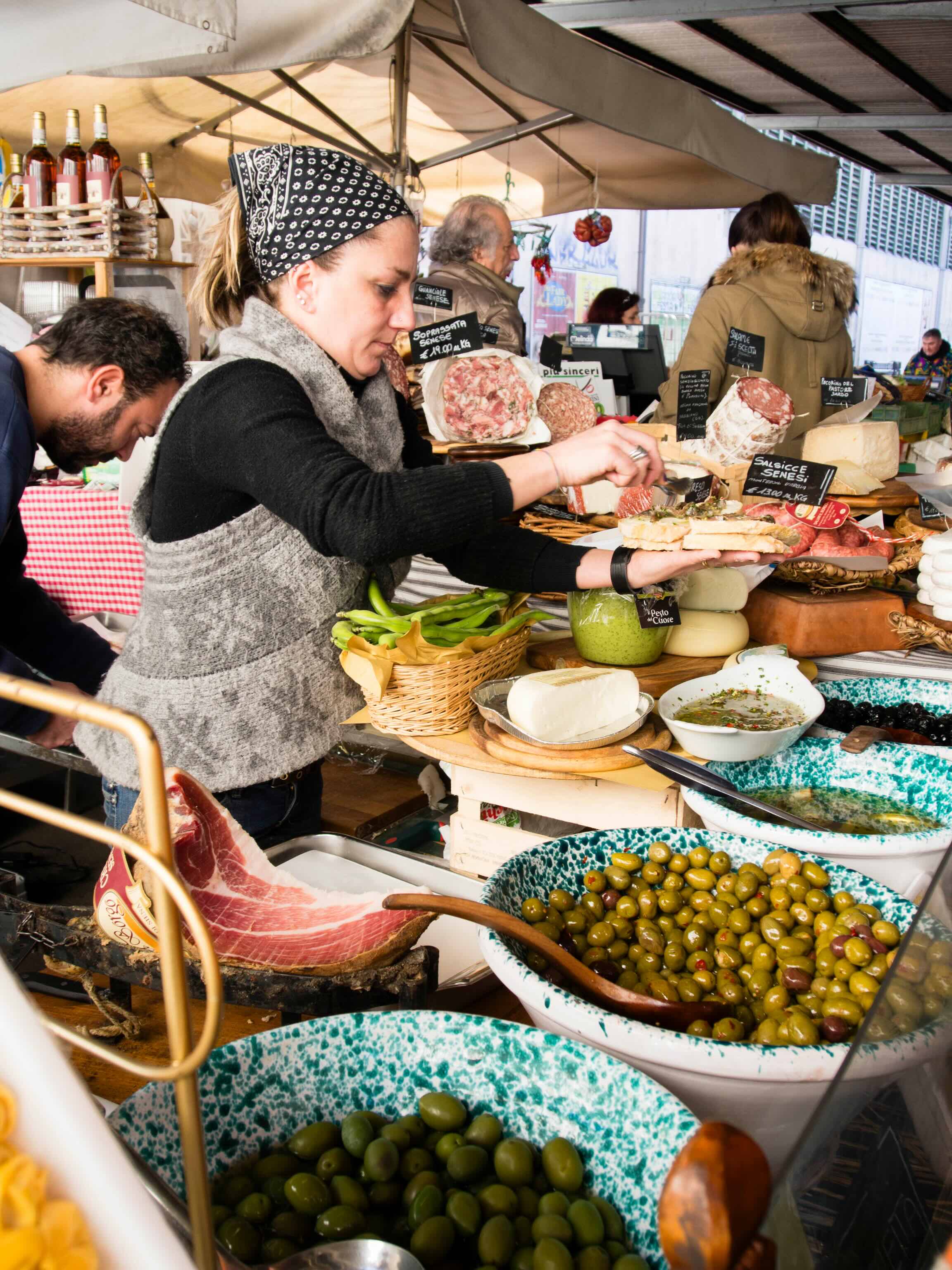 Vendor preparing food at a market stall